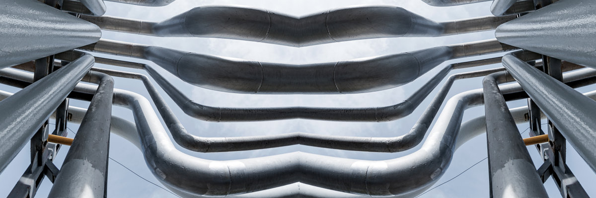 A view looking up with steel pipelines overhead into the sky, two halves mirrored in the style of Ammonia Avenue.